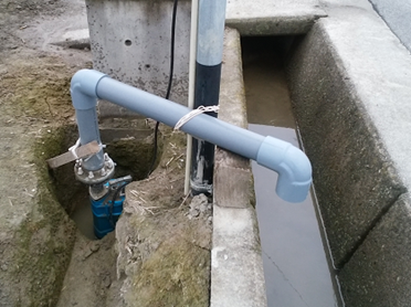 用水へ延びる排水ポンプ